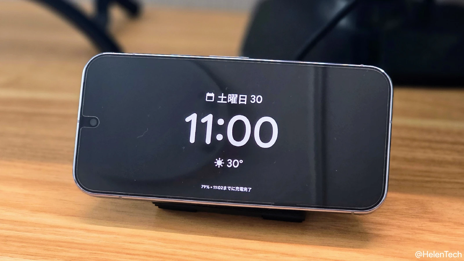 Pixel 10 Pro で Qi2 マグネット充電をして、新しく導入されたロック画面スクリーンセーバーを表示させているところの写真