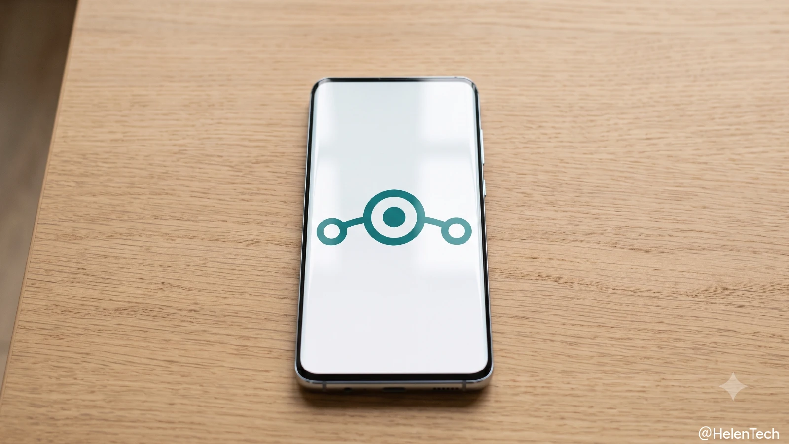 LineageOS のロゴが表示されたスマートフォンが卓上に置かれている様子